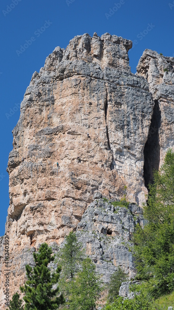 Cortina, Italy. Amazing view of the climbers on the walls of the famous rocks of the 5 towers. Extreme climbing. Outdoors activities. Dolomites Unesco world heritage. Dolomites in Italy. summer time