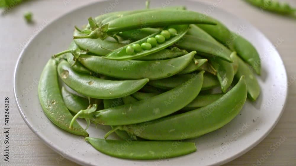fresh sweet green peas on white plate fresh sweet green peas on white plate