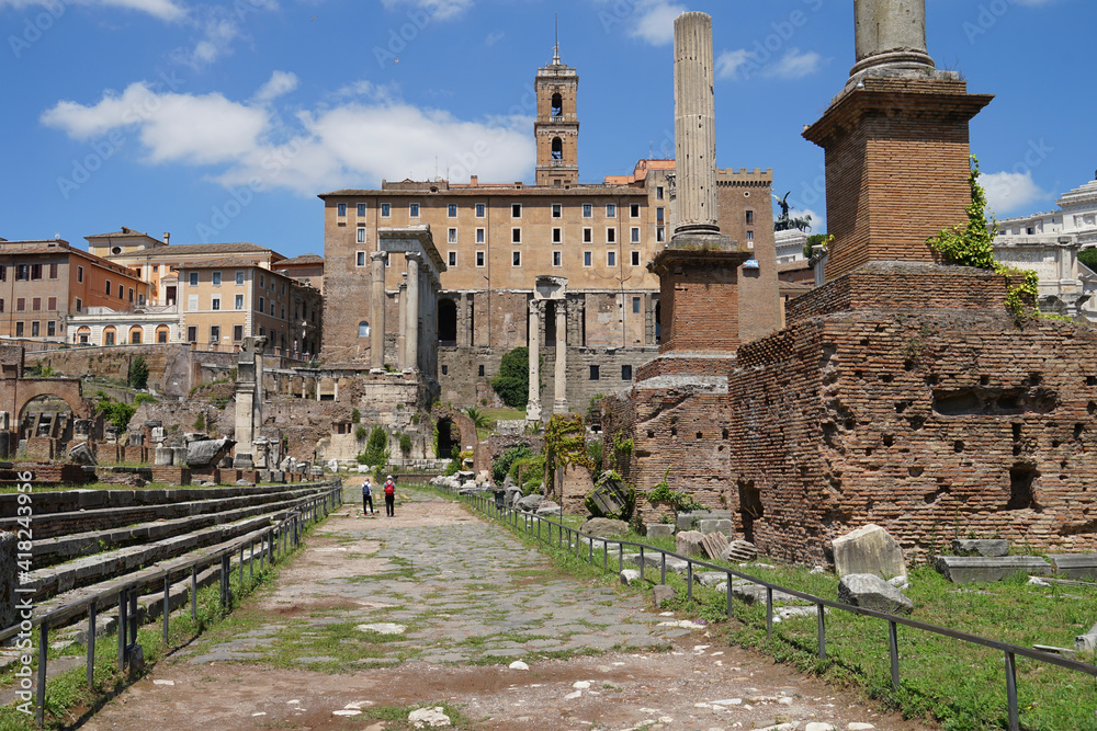 Temple ruins in Ancient Roman Forum, heart of Roman Empire, famous tourist landmark, guided tour concept, Rome, Italy