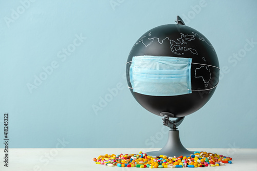 Globe with medical mask and...