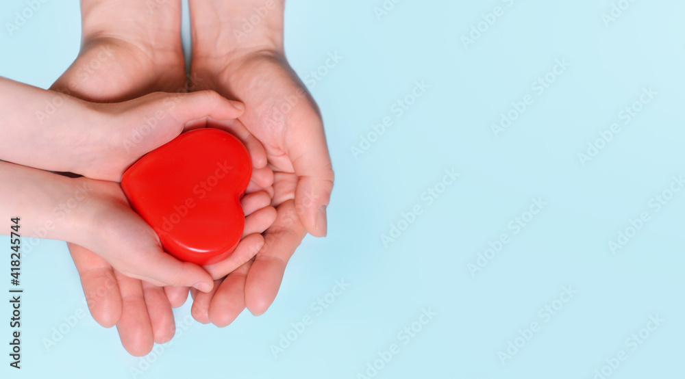 Man give red heart to kid as couple. Healthcare and hospital medical concept. Symbolic of Valentine day.Top view with space for text. Man give red heart to kid as couple. Healthcare and hospital medical concept. Symbolic of Valentine day.Top view with space for text.