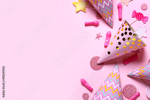 Festive composition with party hats and decor on color background