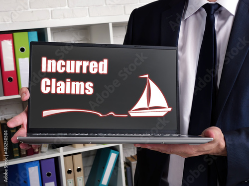 Business concept about Incurred Claims with sign on laptop. photo