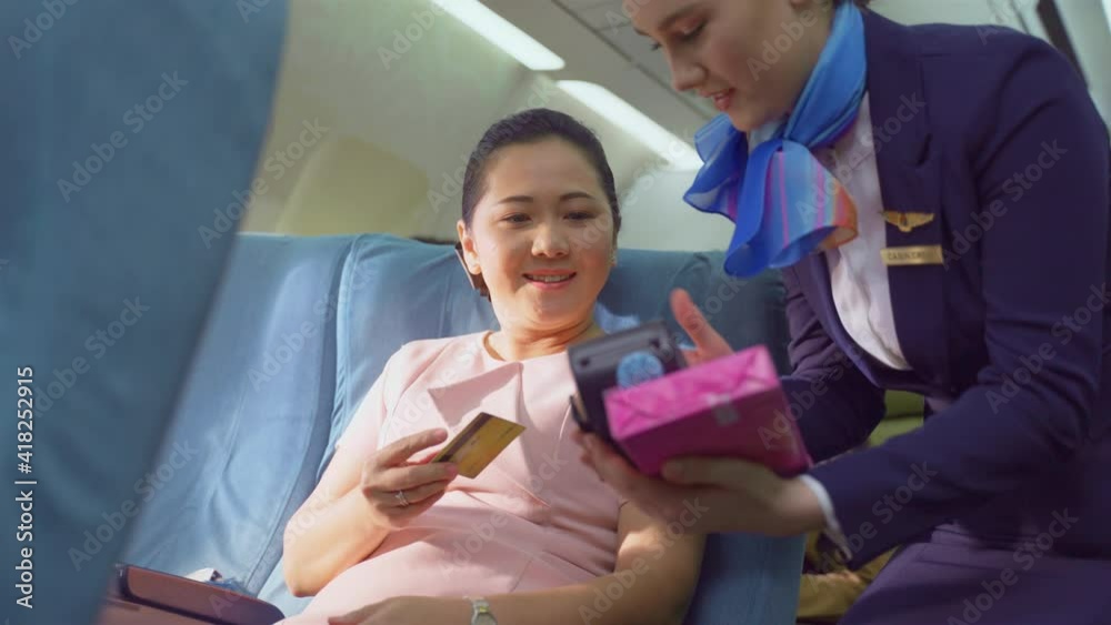Asian businesswoman buying duty free product, pay by using credit card