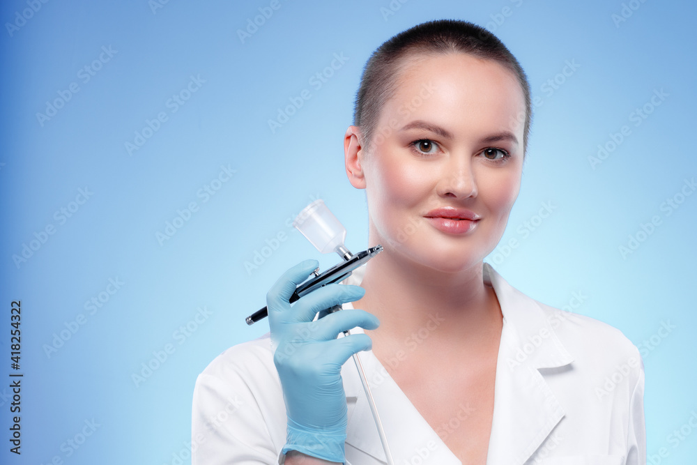 Portrait of a woman dermatologist holding cosmetic device attachment Portrait of a woman dermatologist holding cosmetic device attachment