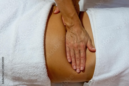 Masseuse giving a face massage to a client