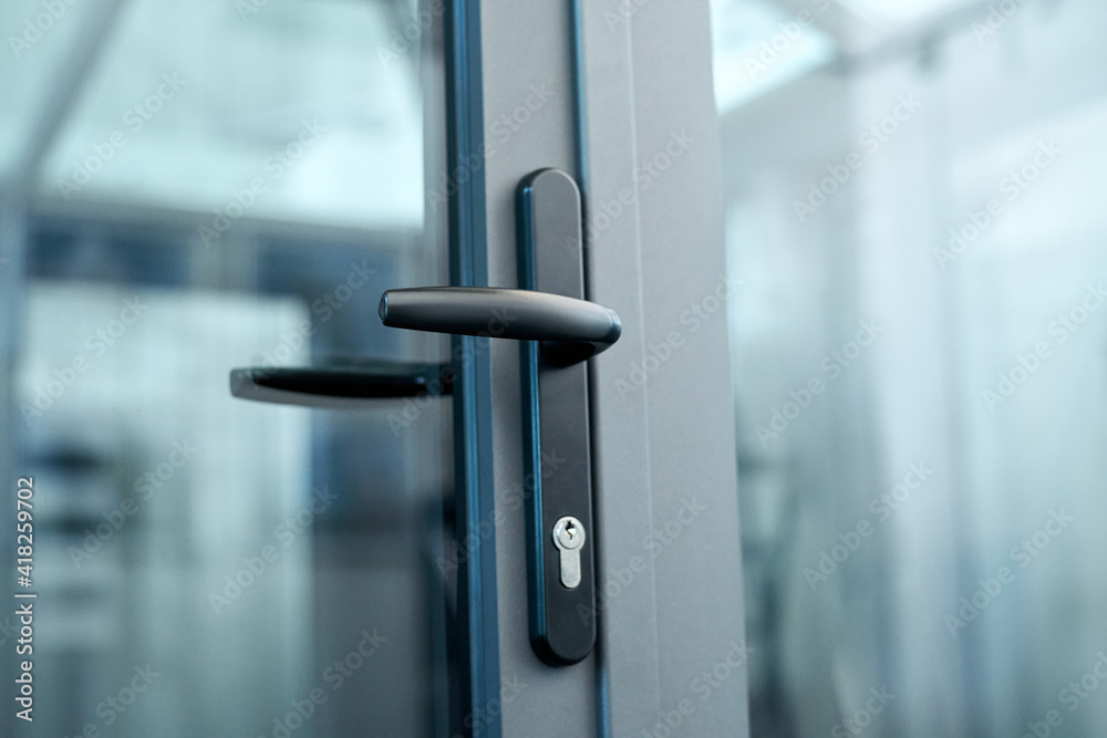 stylish door handle with lock on the glass door. - obrazy, fototapety, plakaty 