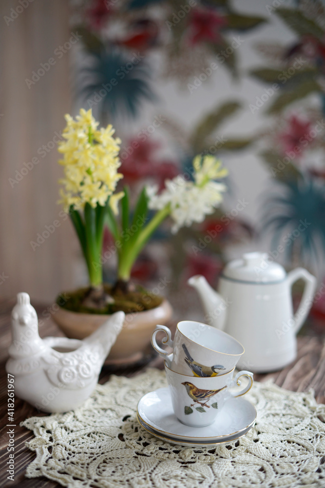 blooming hyacinths and vintage cups on the table