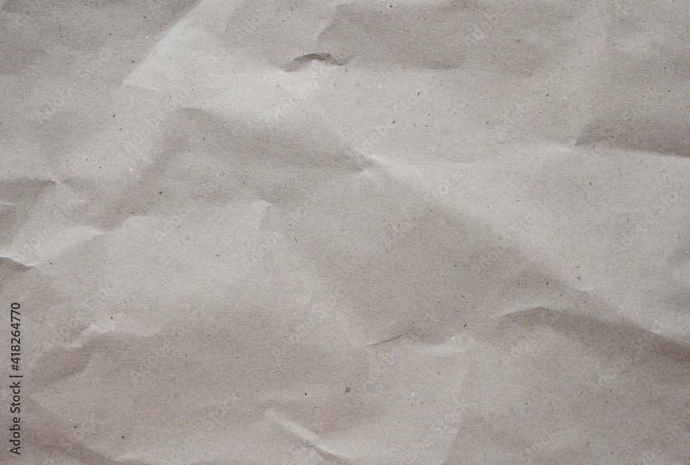 Naklejka premium Crumpled brown kraft paper texture background of paperboard sheet.