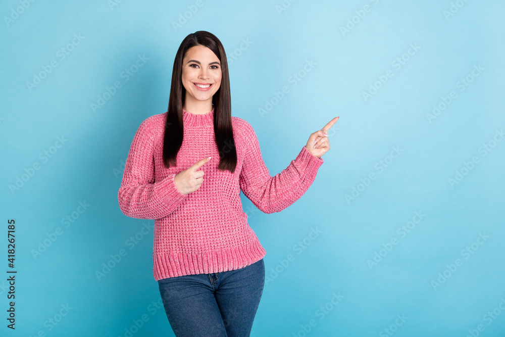 Portrait of charming positive lady indicate fingers empty space proposition isolated on blue color background Portrait of charming positive lady indicate fingers empty space proposition isolated on blue color background