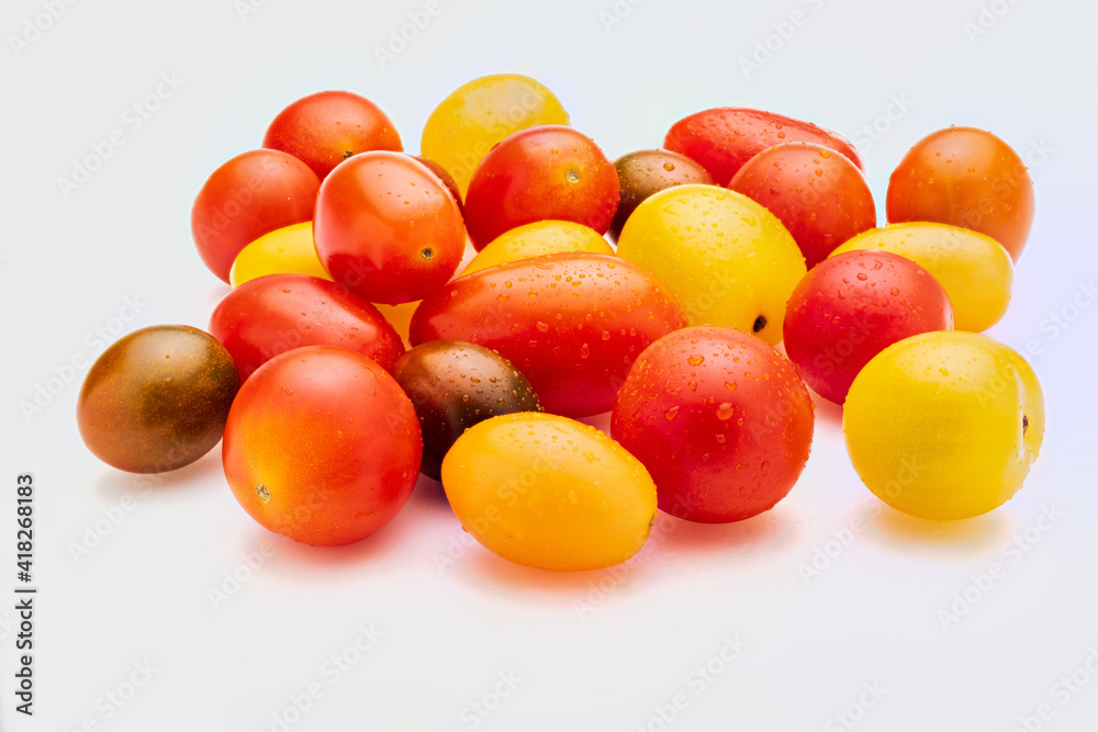 Colorful cherry tomatoes (red, garnet and yellow), fresh and raw. With water drops Isolated on white background. Colorful cherry tomatoes (red, garnet and yellow), fresh and raw. With water drops Isolated on white background.