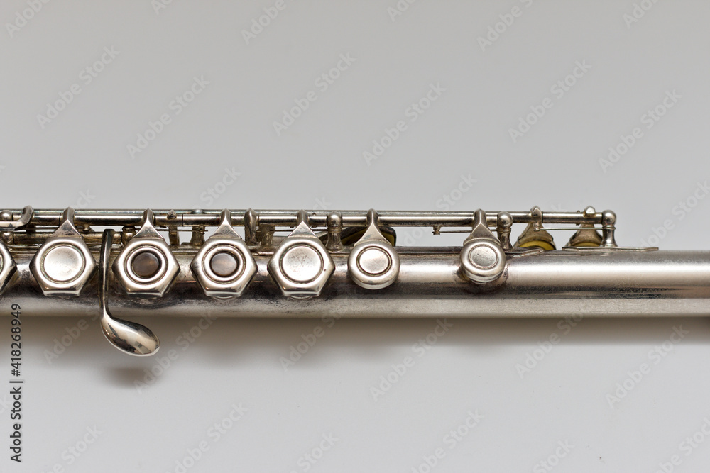 Fototapeta premium Silvery musical instrument with keys on a white background with soft shadow