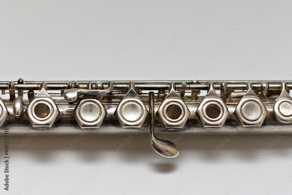 Fototapeta premium Silvery musical instrument with keys on a white background with soft shadow