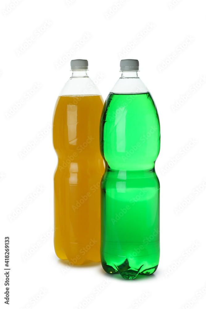 Plastic bottles with green and orange soda isolated on white background Plastic bottles with green and orange soda isolated on white background