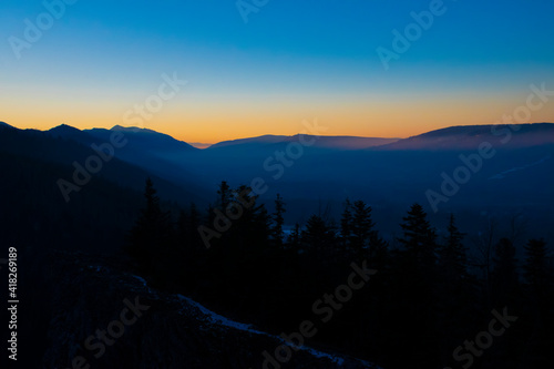 Colorful evening sky over Zakopane town  Poland. The winter is coming to the mountains. Clear sky filled with bright and vibrant colors. Selective focus on a mountain ridge  blurred background.