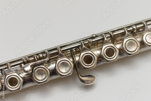 Diagonal close-up image of flute buttons on white background photo