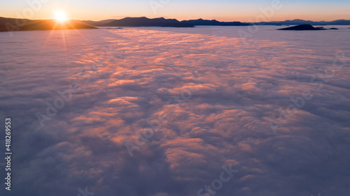 Dawn or sunset over the clouds  blue hour  aerial view.