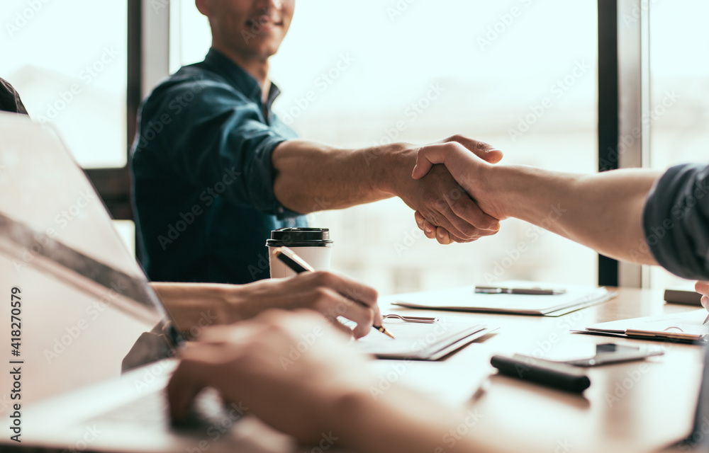 close up. young business people entering into a new contract.