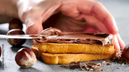 spreading chocolate on bread slice
