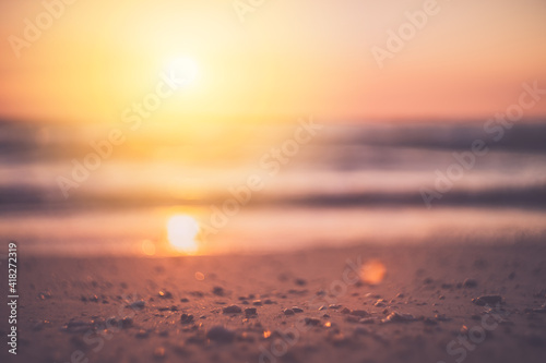 Tropical beach with smooth wave and sunset sky abstract background. © tonktiti