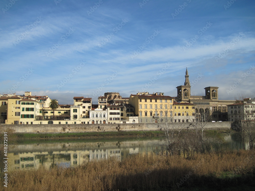 View of the River Arno with historic buildings in the morning. Scenic landscape with old stone building of Gallery Uffizi. Travel to European Union. UNESCO World Heritage Site.