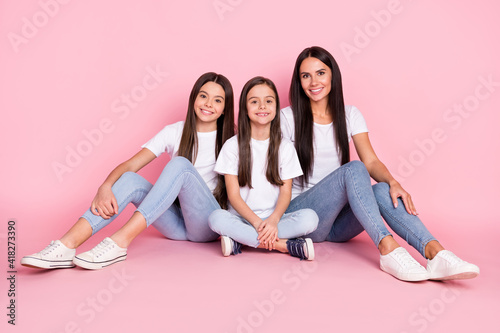 Full size photo of optimistic three woman mom daughters sit wear white cloth isolated on pink background