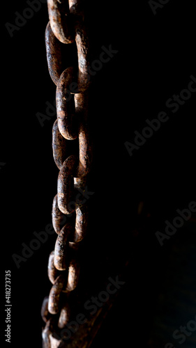 rusty chain from agricultural machinery with dark background