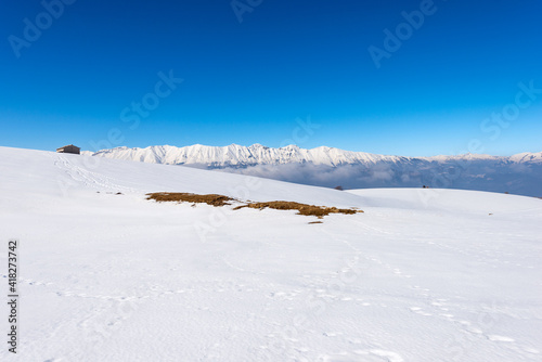 Mountain range of the Monte Baldo and Adamello in winter with snow, view from the Altopiano della Lessinia (Lessinia Plateau), Verona Province. Veneto and Trentino Alto Adige, Italy, Europe. © Alberto Masnovo