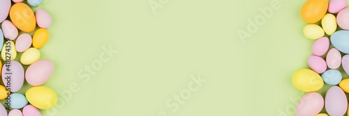 Photography Stylish background with colorful easter eggs pastel colors isolated on green background