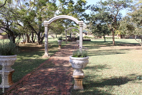 arch along a stone path with trees