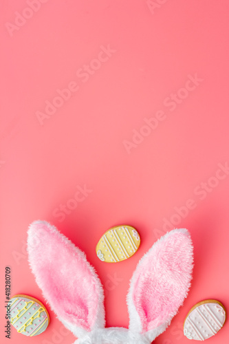 Happy Easter. Bunny ears with colorful eggs cookie, top view