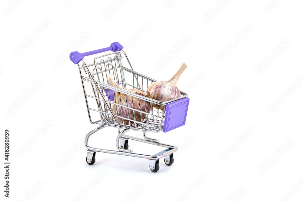 Ripe garlic in a supermarket trolley on a white background Ripe garlic in a supermarket trolley on a white background