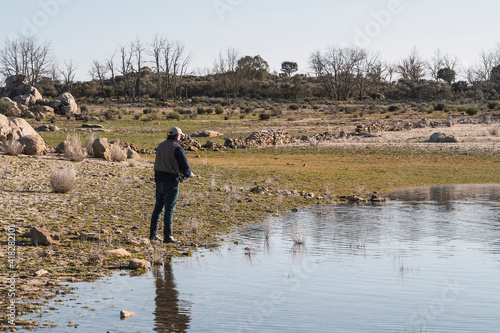 A man with a fishing rod fishing