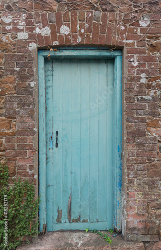 old blue door in wall