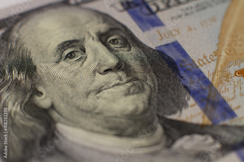 Close-up shot of a new 100 dollar bill. On a white background