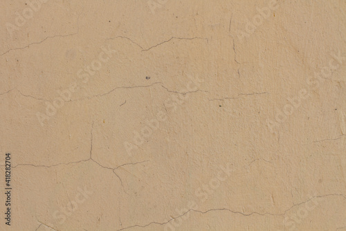cracked cream plaster. Background with natural cracks © Studiomiracle