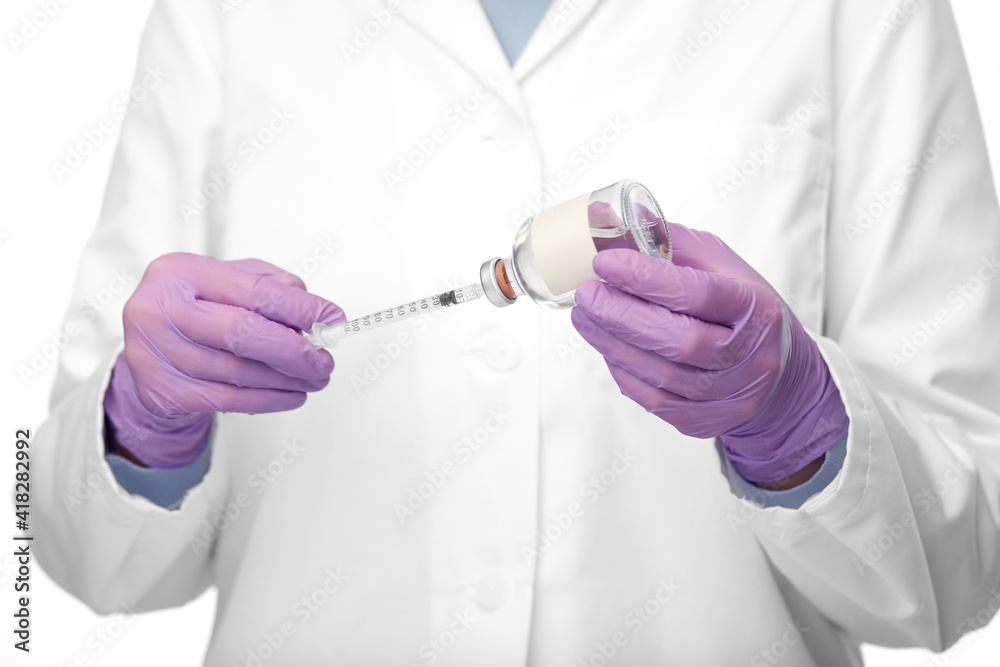 medicine, vaccination and healthcare concept - close up of female doctor or nurse in gloves with drug and syringe over white background medicine, vaccination and healthcare concept - close up of female doctor or nurse in gloves with drug and syringe over white background
