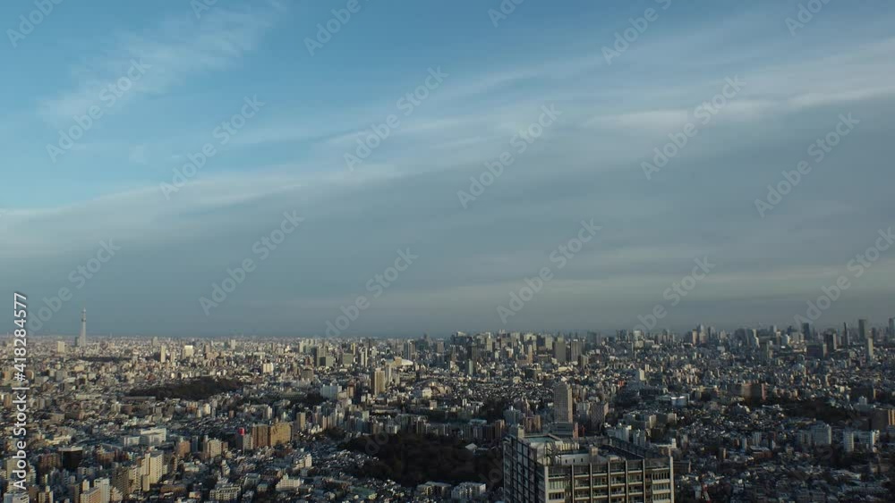TOKYO, JAPAN : Aerial high angle sunset CITYSCAPE of TOKYO. View of buildings at central downtown area. Japanese city life and urban metropolis concept. Long time lapse zoom in shot, dusk to night. TOKYO, JAPAN : Aerial high angle sunset CITYSCAPE of TOKYO. View of buildings at central downtown area. Japanese city life and urban metropolis concept. Long time lapse zoom in shot, dusk to night.