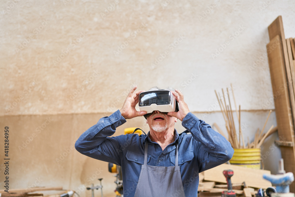Craftsman senior with VR glasses for visualization Craftsman senior with VR glasses for visualization