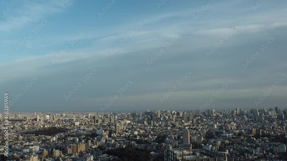 TOKYO, JAPAN : Aerial high angle sunset CITYSCAPE of TOKYO. View of buildings at central downtown area. Japanese city life and urban metropolis concept. Long time lapse zoom out shot, dusk to night. TOKYO, JAPAN : Aerial high angle sunset CITYSCAPE of TOKYO. View of buildings at central downtown area. Japanese city life and urban metropolis concept. Long time lapse zoom out shot, dusk to night.