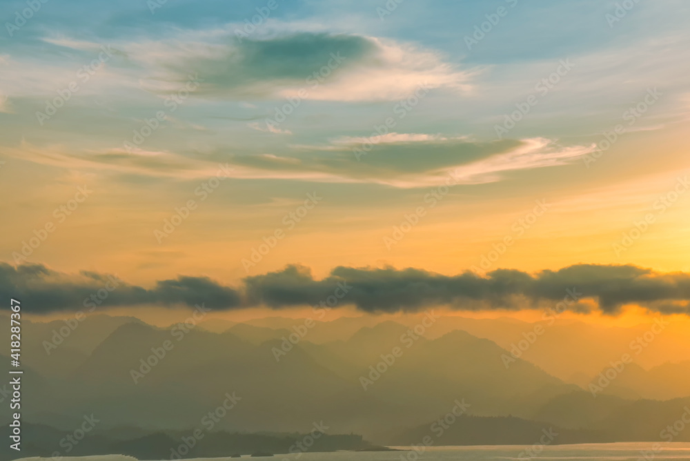 Beautiful scenery with clouds during sunrise with mountain view as background.