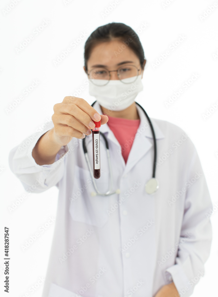 Portrait of Asian female doctor in white gown coat wearing eyes glasses in white background holding test tube of coronavirus covid 19 vaccine sample Portrait of Asian female doctor in white gown coat wearing eyes glasses in white background holding test tube of coronavirus covid 19 vaccine sample