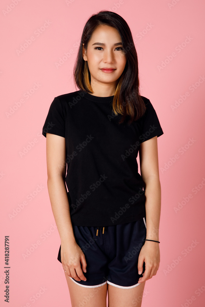 Obraz premium Active and sporty character young and cute Asian girl in t-shirt and shorts posing to the camera with self-confidence.