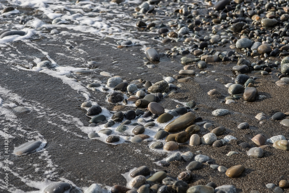 Sea shore with stones and foam, pebble seascape. Sea shore with stones and foam, pebble seascape.