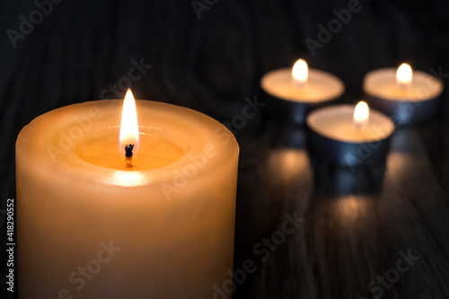 Tragedy. Death. Candles on a wooden background.