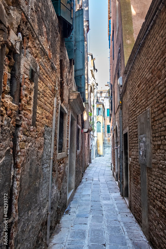 Old historic buildings along a narrow street. Venice  Italy