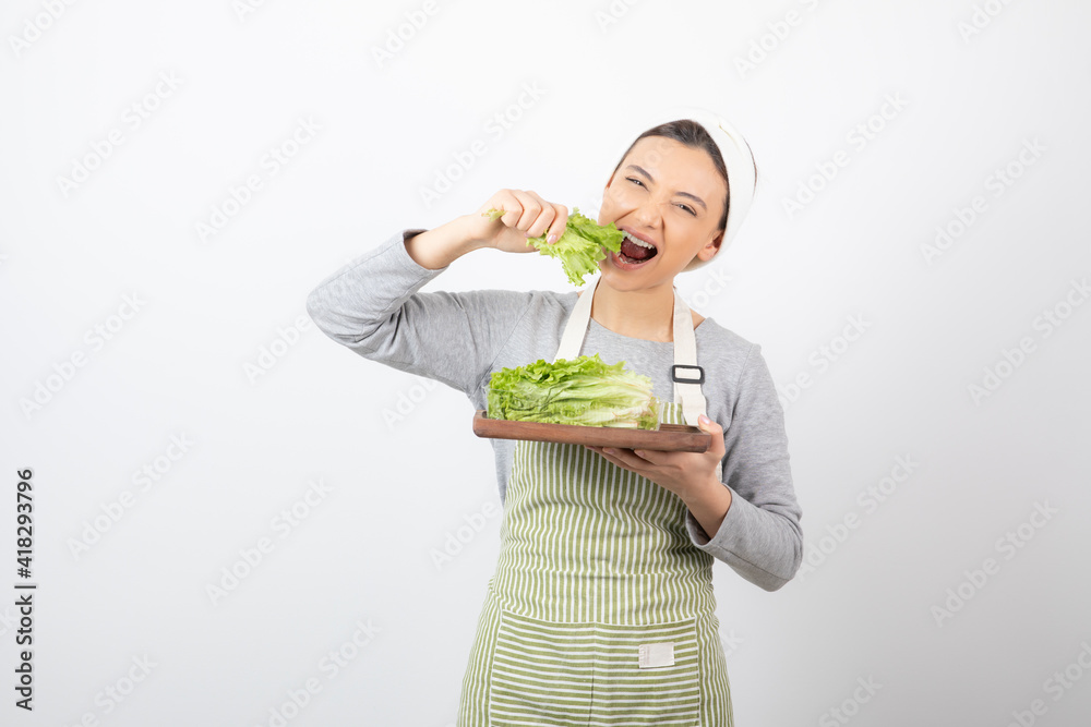 Portrait of a pretty cute woman eating fresh lettuce Portrait of a pretty cute woman eating fresh lettuce