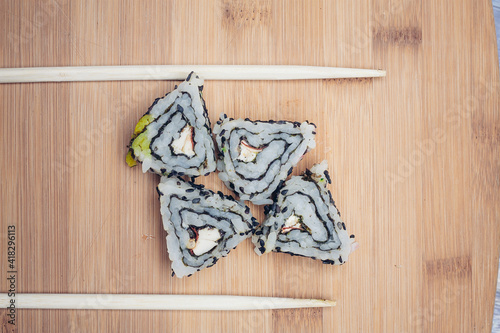 triangular sushi rolls chopsticks wooden background asian cuisine