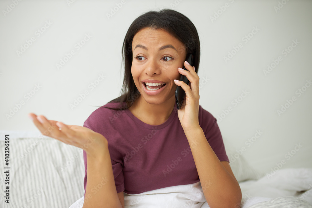 Genuine human reactions, feelings and technology. Headshot of amazed attractive young black woman raising eyebrows, making surprised gesture, gasping, expressing astonishment, talking on cell phone Genuine human reactions, feelings and technology. Headshot of amazed attractive young black woman raising eyebrows, making surprised gesture, gasping, expressing astonishment, talking on cell phone