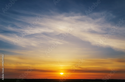 Fototapeta Naklejka Na Ścianę i Meble -  Stunning sunset with orange and blue clouds in dramatic sky